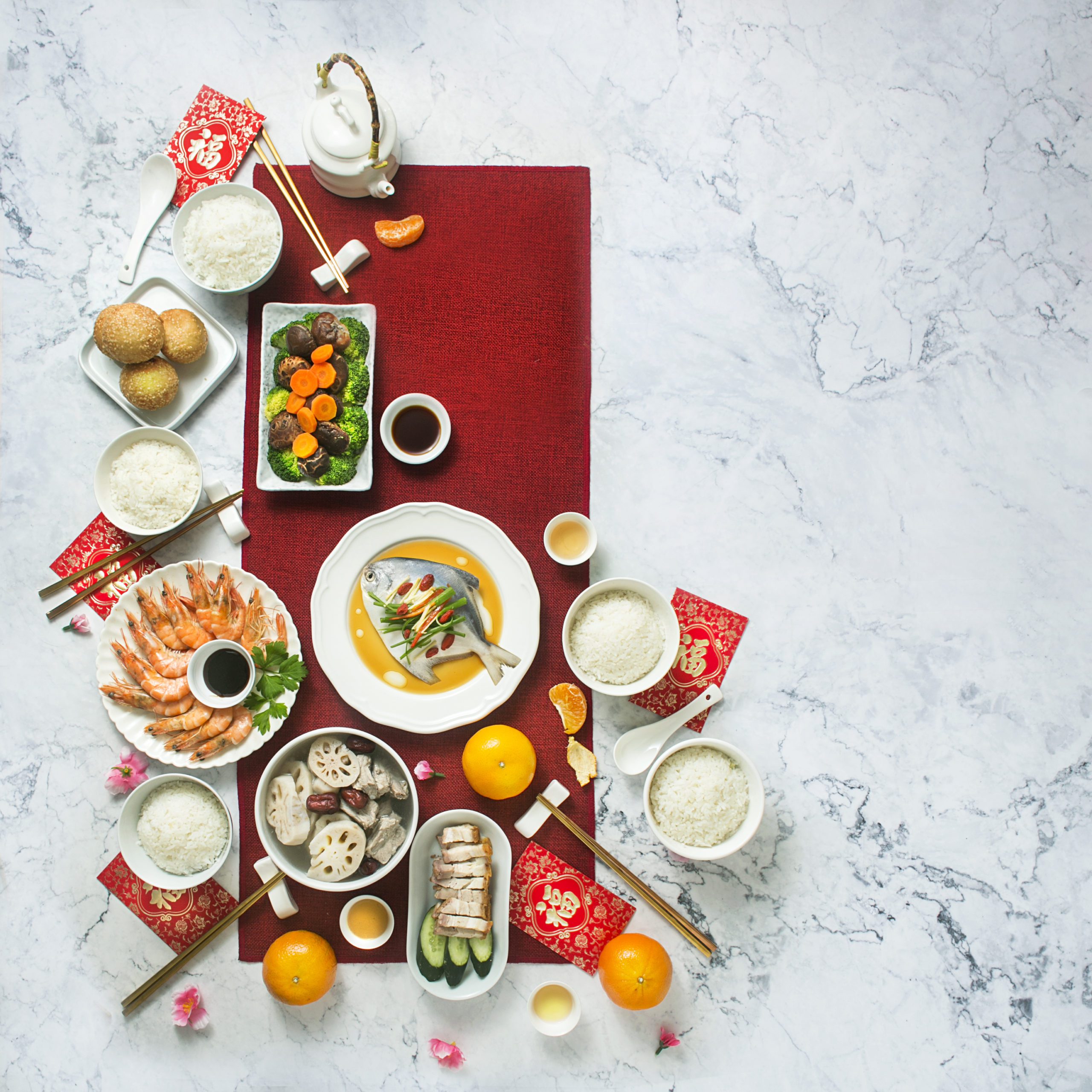 Flat lay Chinese new year reunion dinner, food and drink. Marble top background.